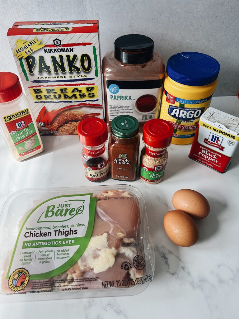 seasonings, spices, eggs, and chicken thighs lined up to make chicken katsu.