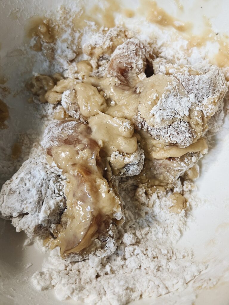 chicken thighs battered and floured ready to fry