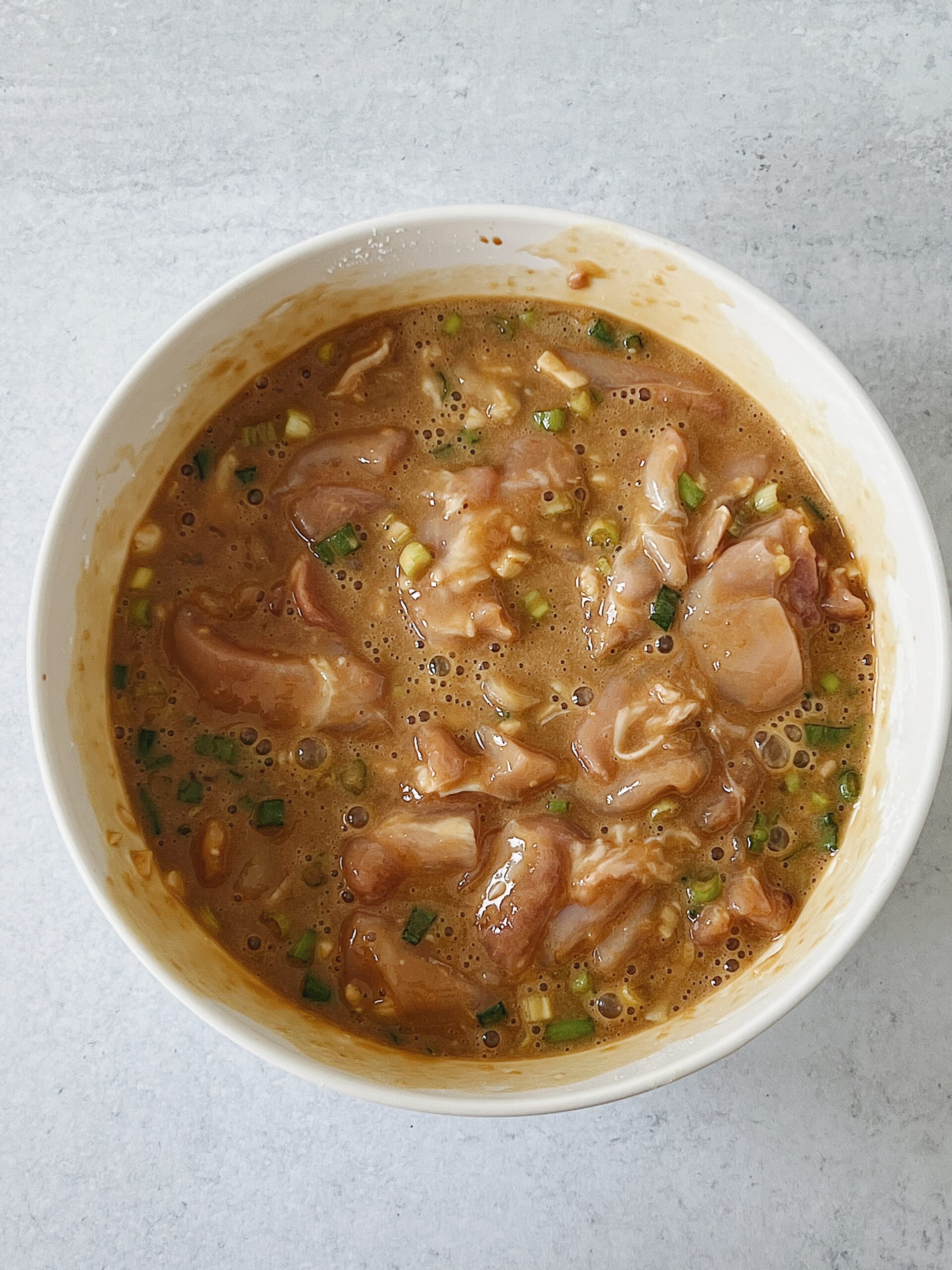 marinated chicken thighs in a bowl.