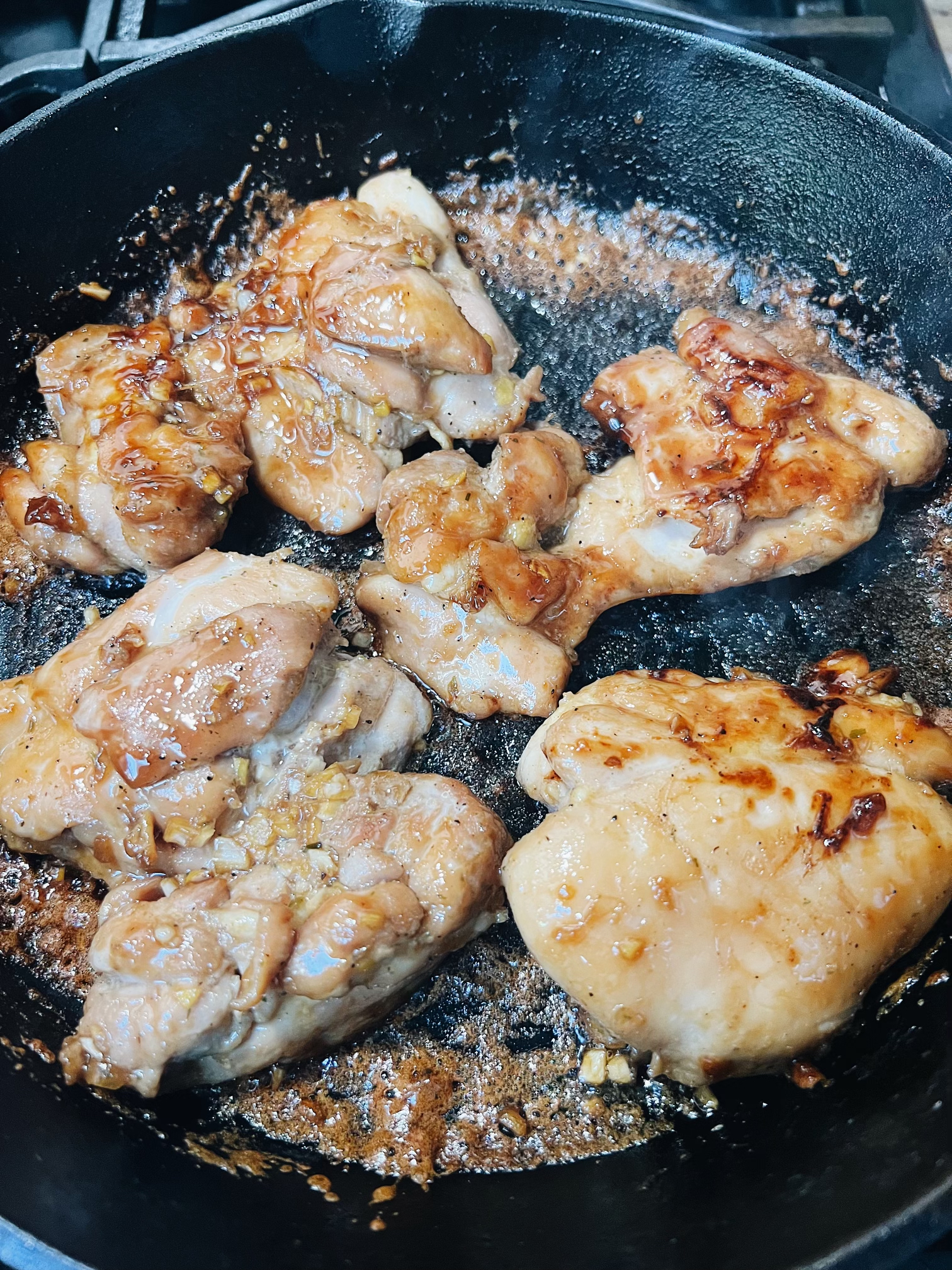 Chicken Teriyaki cooking on a cast iron skillet